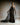 Schmales Abendkleid CELESTIAL mit Bustier‑Oberteil und Organza‑Volant, Frontansicht im Studio.