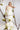 Modernes Hochzeitskleid VIOLA mit applizierten Plissees am Bustier und eleganter, bodenlanger Seidencrepe‑Silhouette.
