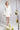 Kurzes Braut Blazer‑Kleid CARRY mit eleganter, moderner Silhouette und V‑Ausschnitt, Frontansicht im Studio.