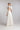 Brautkleid FIRN mit tiefem Ausschnitt, schmalen Spaghettiträgern aus Seidenchiffon und skulpturalem BLÜTENKRAGEN aus Organza, Rückansicht.