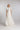 Brautkleid FIRN, Frontansicht mit fließendem, bodenlangem Seidenchiffon‑Rock und dramatischem Blütenkragen am Hals.