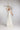 FIRN Hochzeitskleid mit tiefem Ausschnitt, Spaghettiträgern und großzügigem Organza BLÜTENKRAGEN, Braut hält Blütenzweig.
