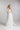 FLORA One‑Shoulder Brautkleid aus feinem Seidenchiffon mit abnehmbarer Blüte, Frontansicht im Studio.